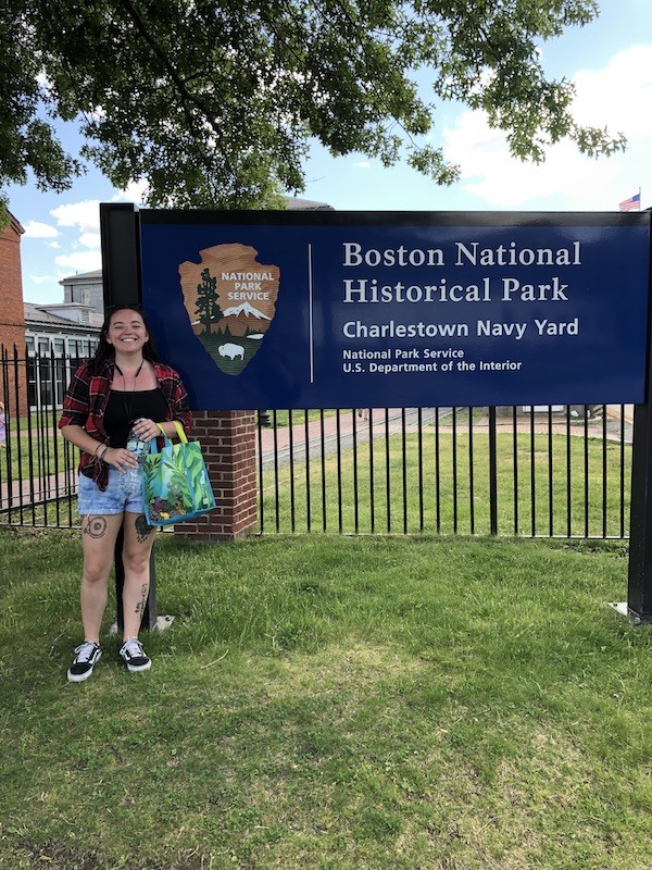Juliann Ramos pictured in front of the Boston National Historical Park sign