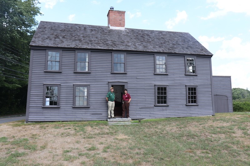 two national park volunteers standing outside the meriam house