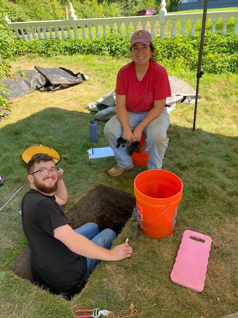 two American conservation experience members at an archeological dig