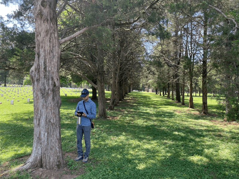 Craig taking readings while working at a cemetery