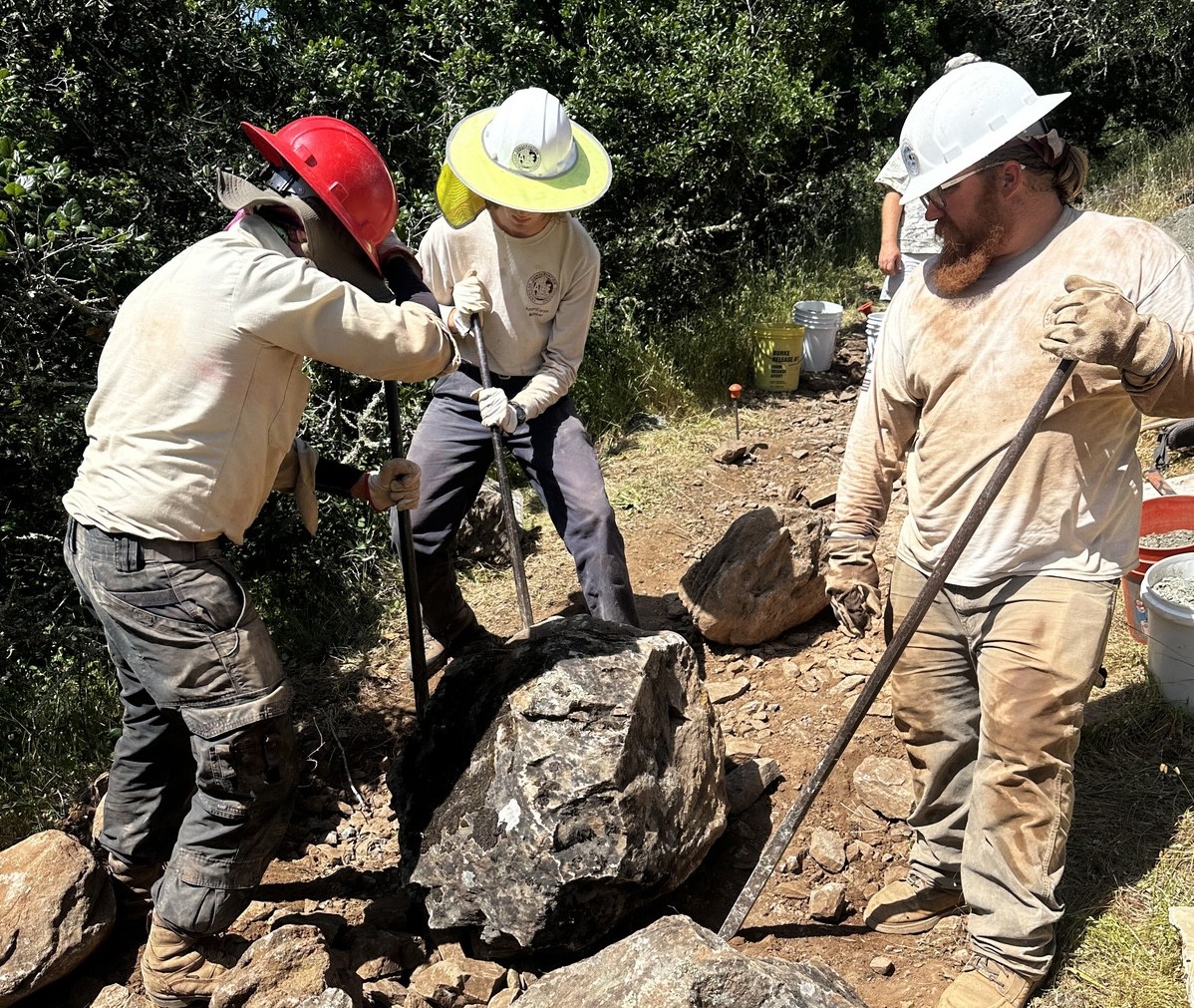 ACE members moving small boulder