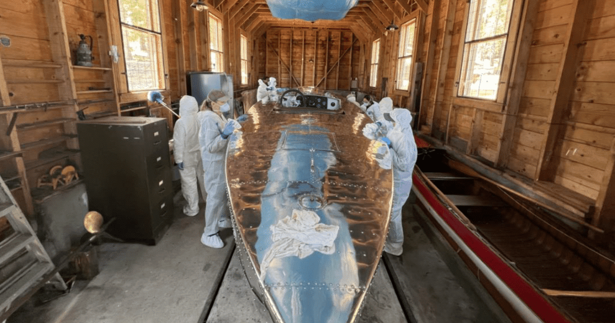 ACE intern cleaning a historic boat