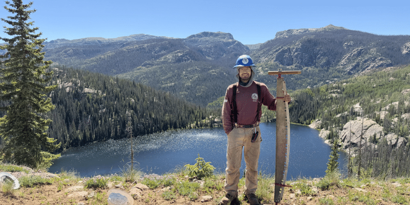 More than a trail article image 3 ACE member holding crosscut saw